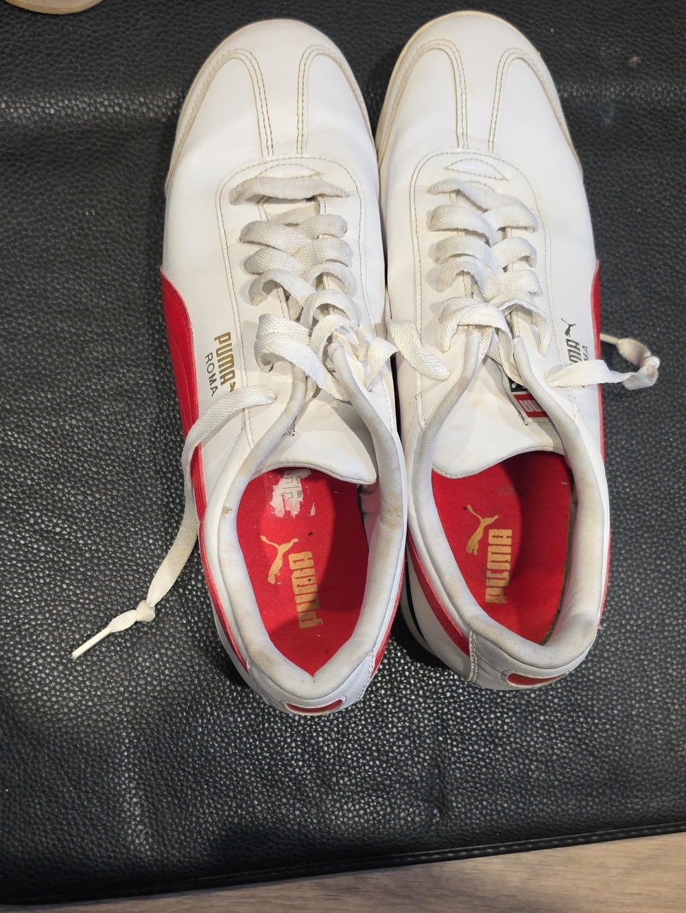 Puma White Sneakers with Red Accents and Gold Logo
